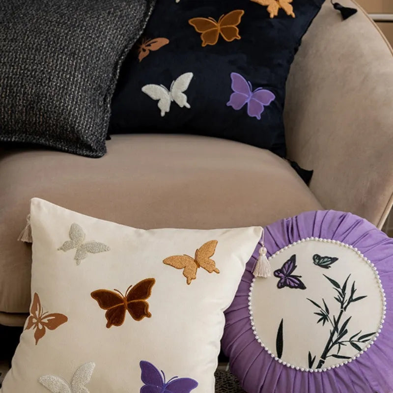 Square beige cushion with detailed Chinese style butterfly embroidery.