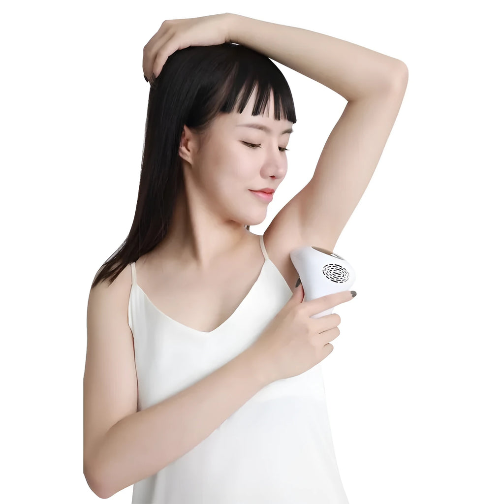 Compact laser hair removal handset in dark green with 8 power levels and skin rejuvenation