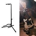 Black metal guitar floor stand holding an acoustic guitar.