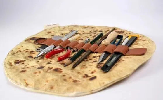 Fabric simulation burrito pencil case in clay oven rolls style, 22cm square, on a desk with pens inside