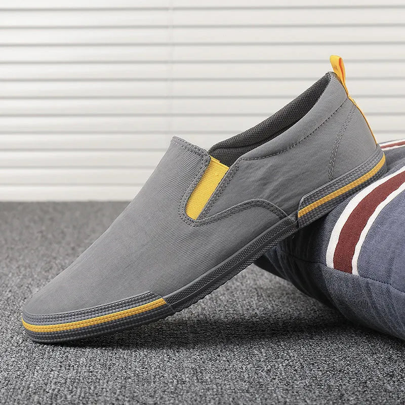 Men's low-top canvas sneakers in grey, black orange, and khaki colours with round toe and vulcanised rubber soles