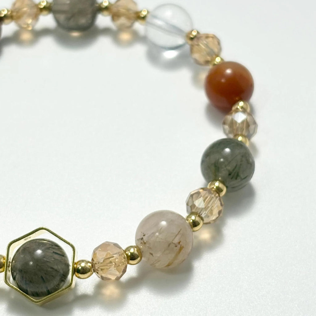 Gold crystal bracelet with 8mm beads showing hand-woven construction and traditional auspicious symbols