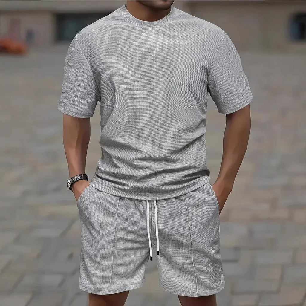 Man wearing a white waffle texture short sleeve blouse and matching shorts summer set.