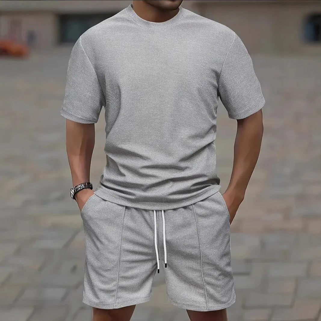 Man wearing a white waffle texture short sleeve blouse and matching shorts summer set.
