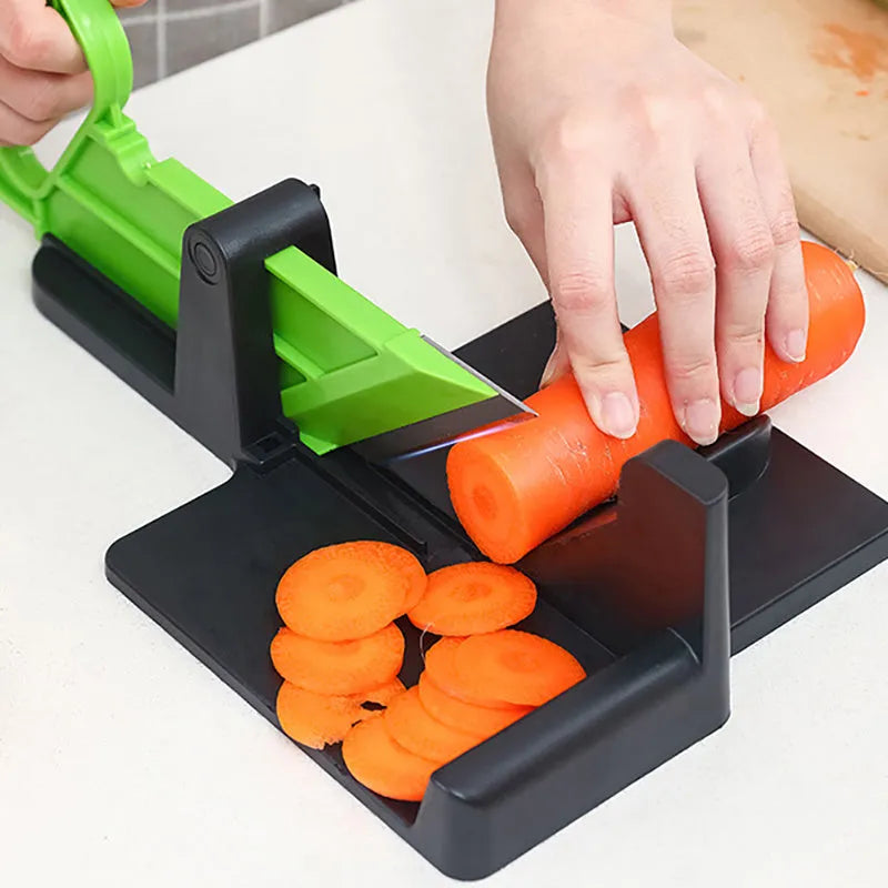 Green vegetable cutter with stainless steel blades for carrot and potato slicing in kitchen