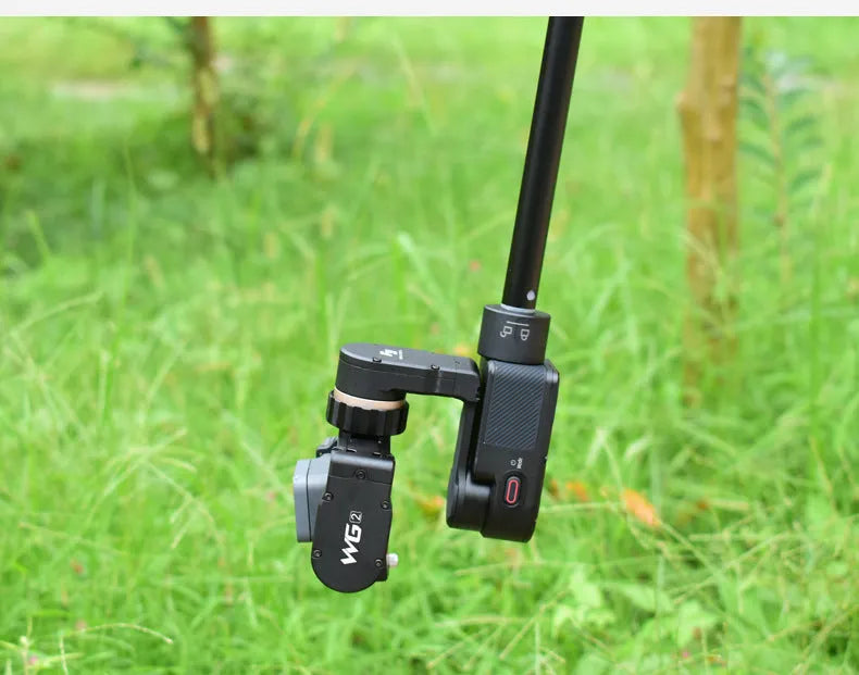 Black retractable aluminium selfie stick extended to 1.2m with a smartphone attached and a Bluetooth remote.