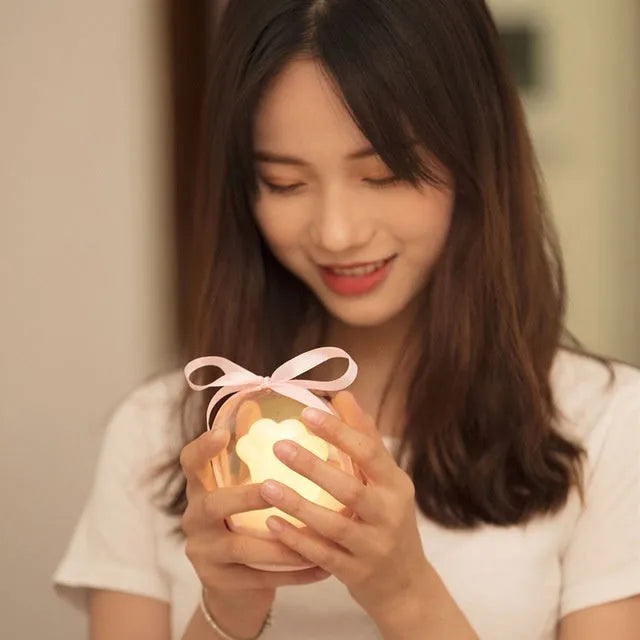 Pink cat paw shaped night light with USB charging cable and music box function