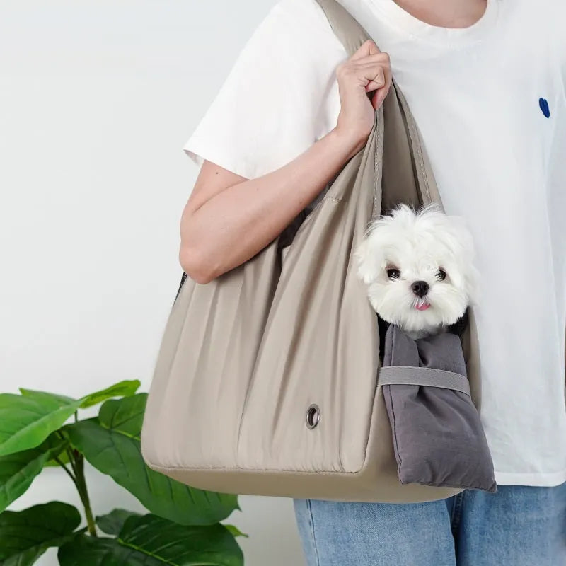Apricot coloured cloth pet carrier handbag showing portable size.