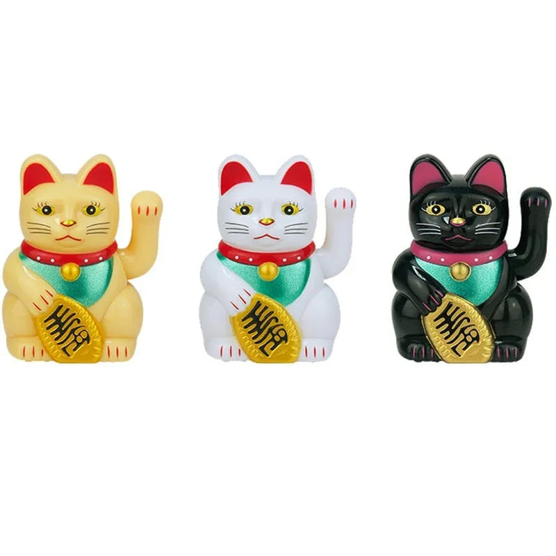 Small yellow solar-powered Maneki Neko lucky cat decoration waving, shown on a car dashboard.