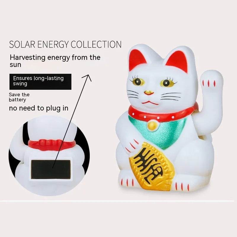 Small yellow solar-powered Maneki Neko lucky cat decoration waving, shown on a car dashboard.