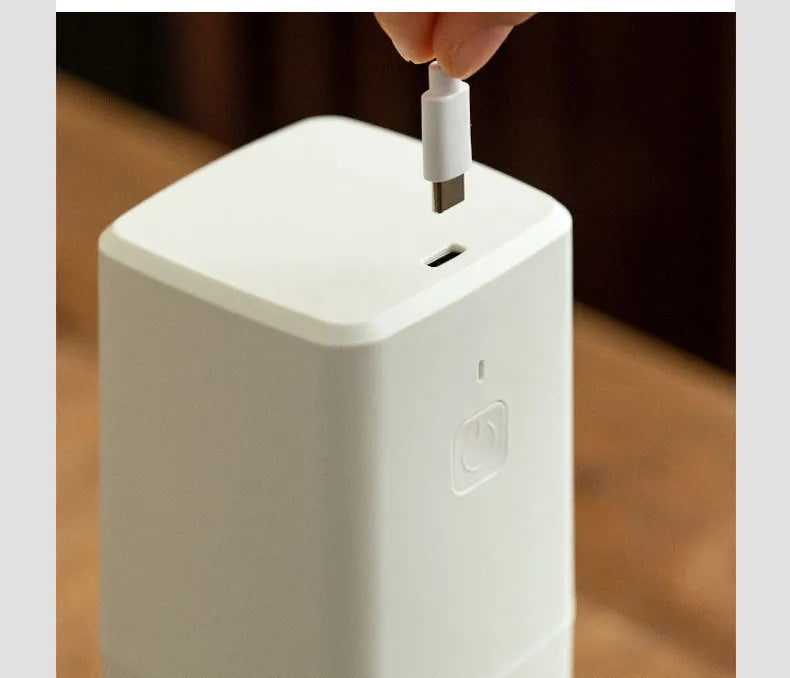 Square electric coffee bean grinder in black with USB Type-C charging port and copper motor, 25-30g capacity