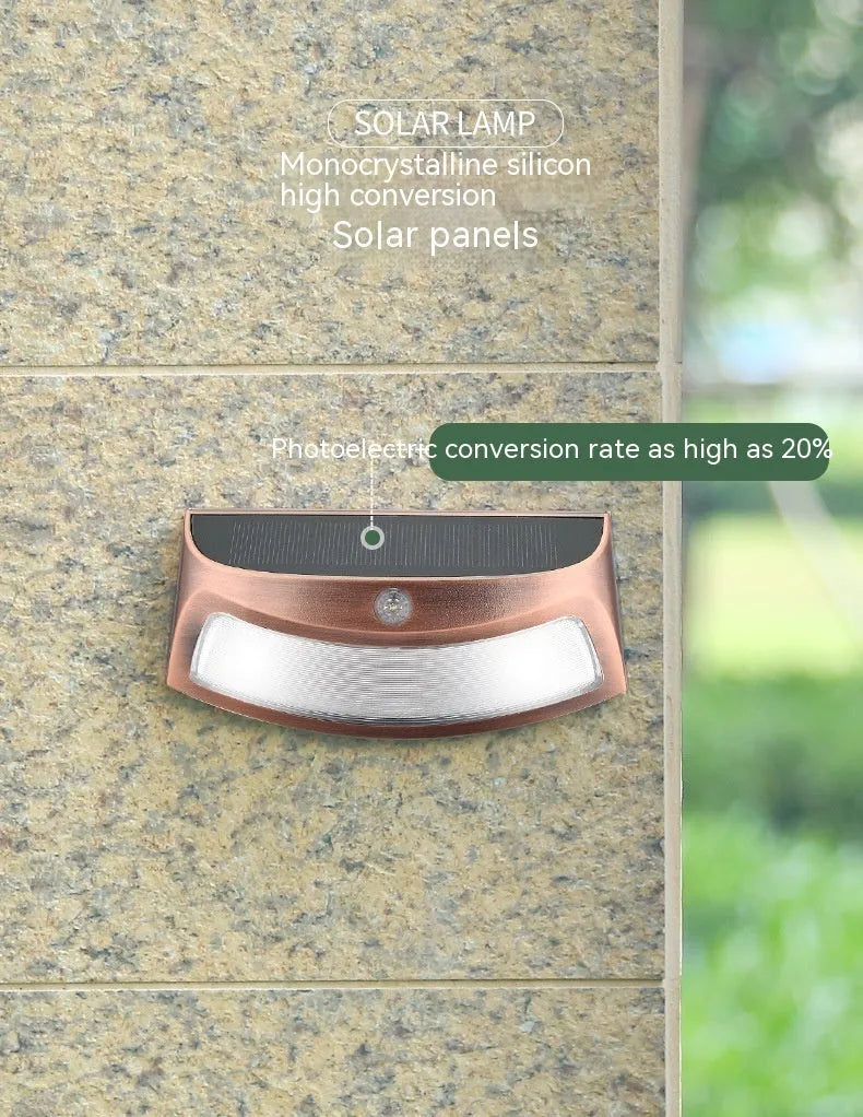 Solar outdoor wall lamp with decorative smiling face design for garden and courtyard lighting