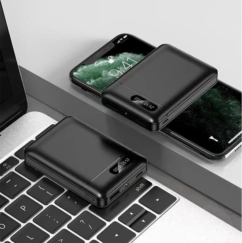 Black or white portable power bank with dual USB ports showing capacity options