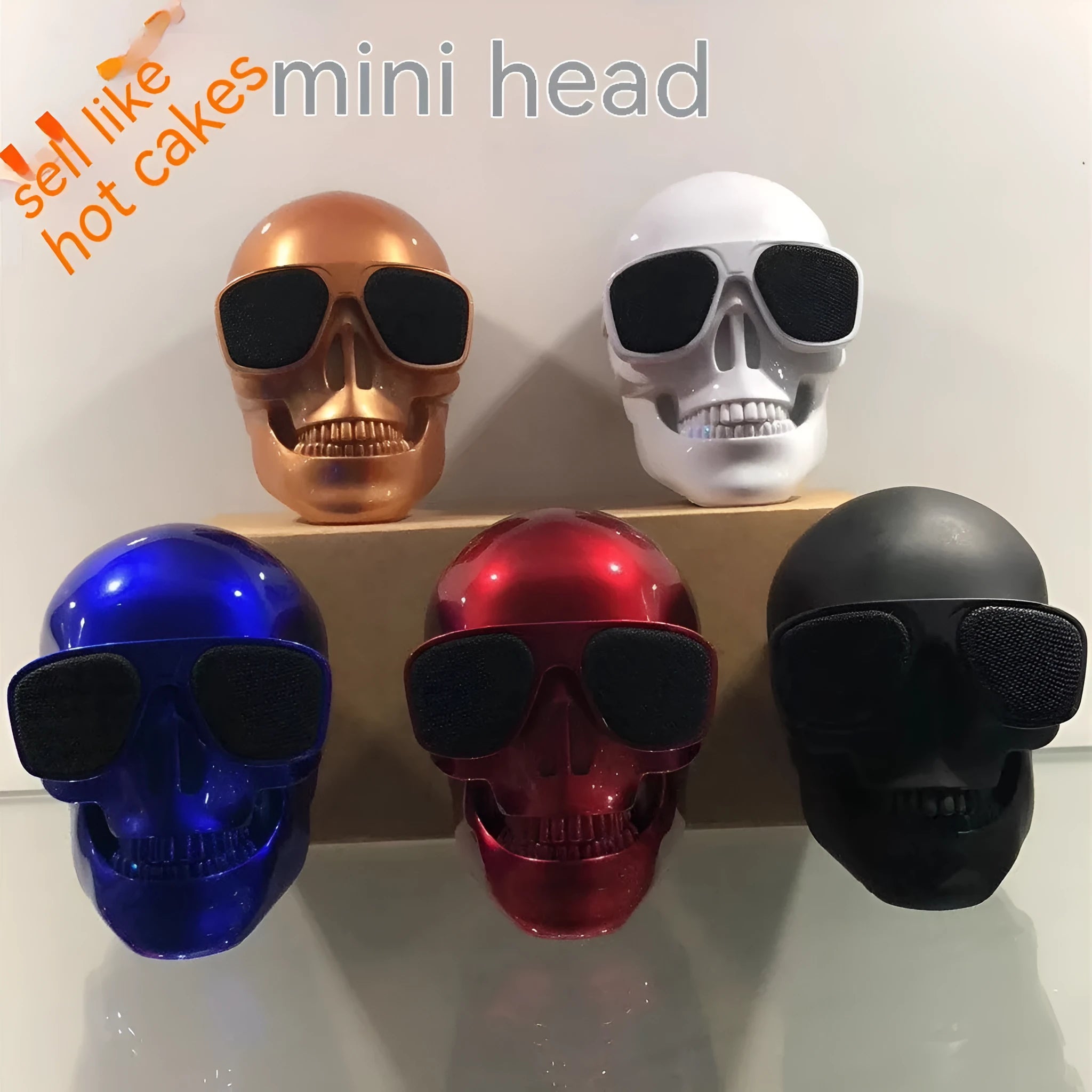 Small skull-shaped wireless Bluetooth speaker in black, portable with button controls and USB charging