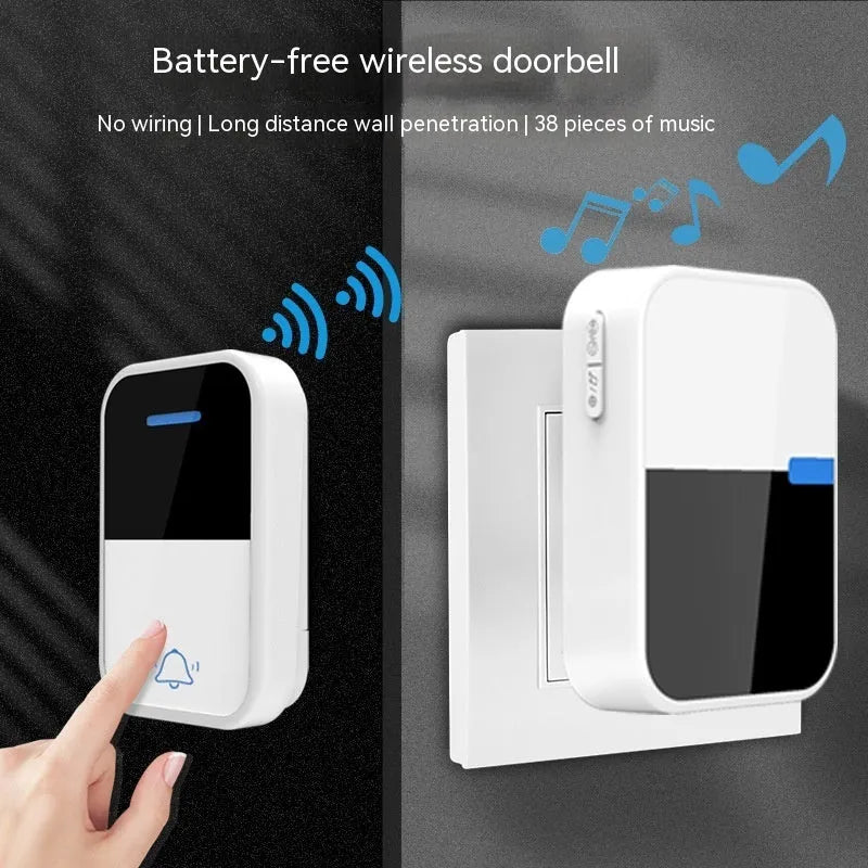 Modern white plastic wireless doorbell receiver and transmitter on a table.