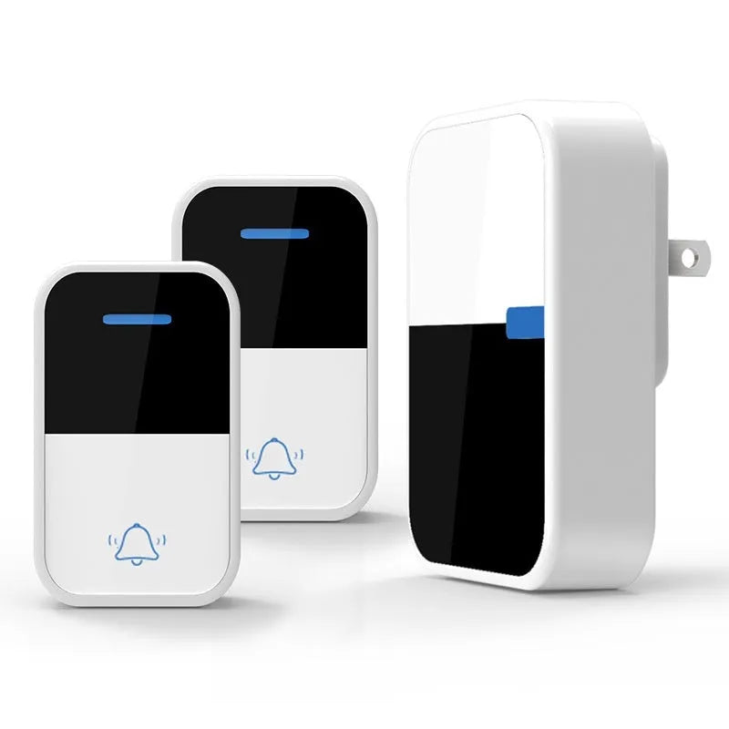 Modern white plastic wireless doorbell receiver and transmitter on a table.