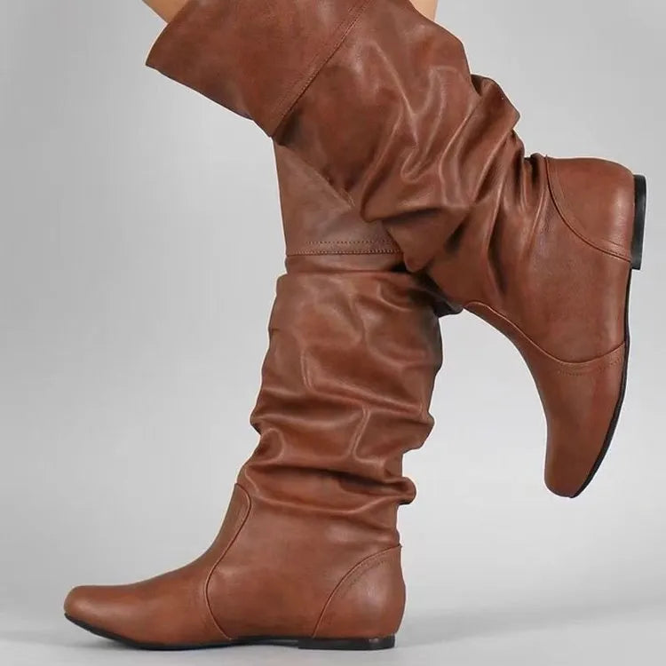 Women's black flat heel slip-on long boots with round toe and high cylinder shaft.