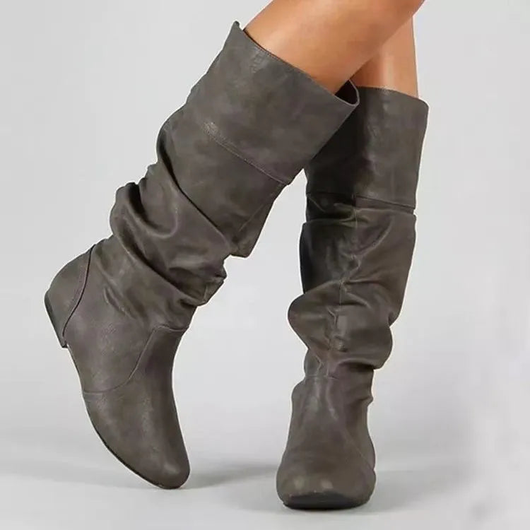 Women's black flat heel slip-on long boots with round toe and high cylinder shaft.