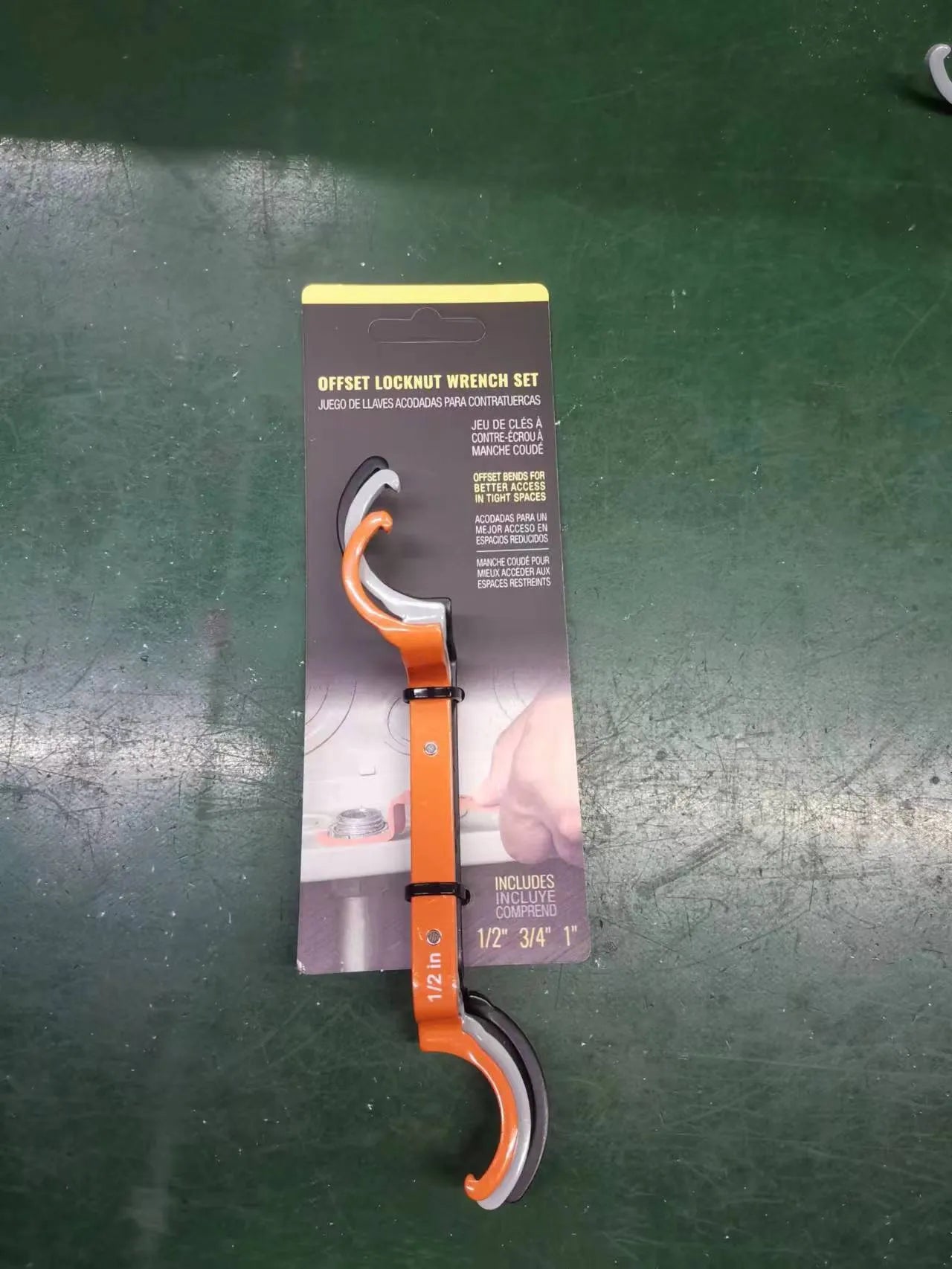 Three colour-coded wrenches in orange, grey and black showing crescent, magnetic and catheter locking designs