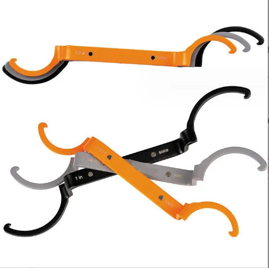 Three colour-coded wrenches in orange, grey and black showing crescent, magnetic and catheter locking designs