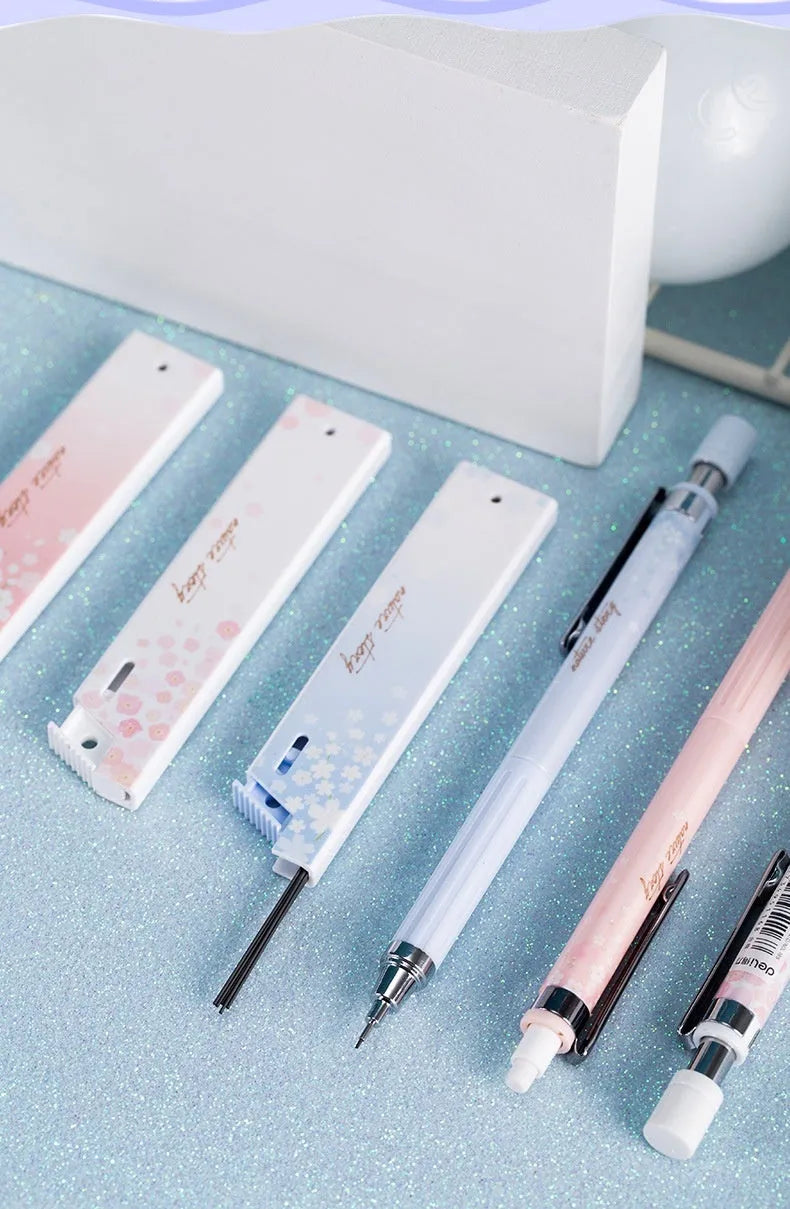 Three 0.5mm Sakura cartoon automatic pencils with HB refill boxes
