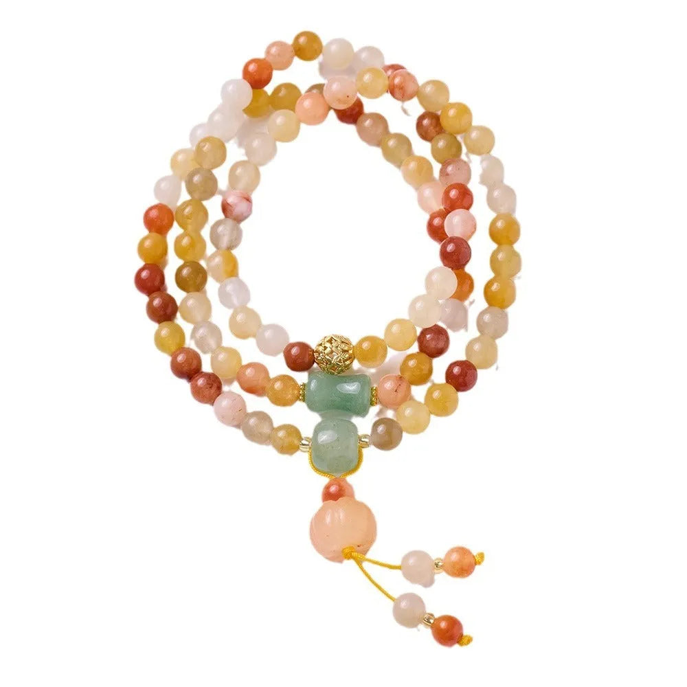 Women's Jinsi Jade bracelet with three-circle pumpkin design and tassels on a wrist