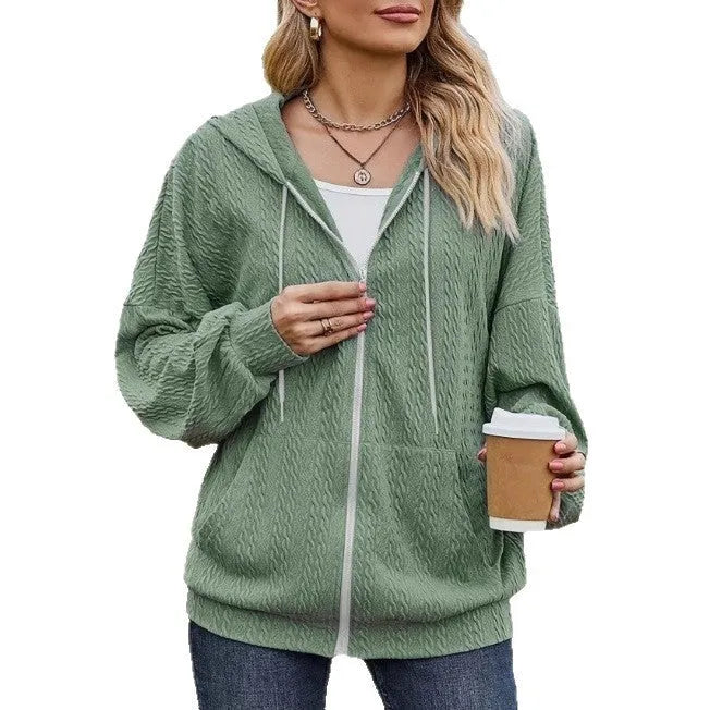 Forest green women's zip-up hooded sweater coat on a hanger, showing loose fit and long sleeves.