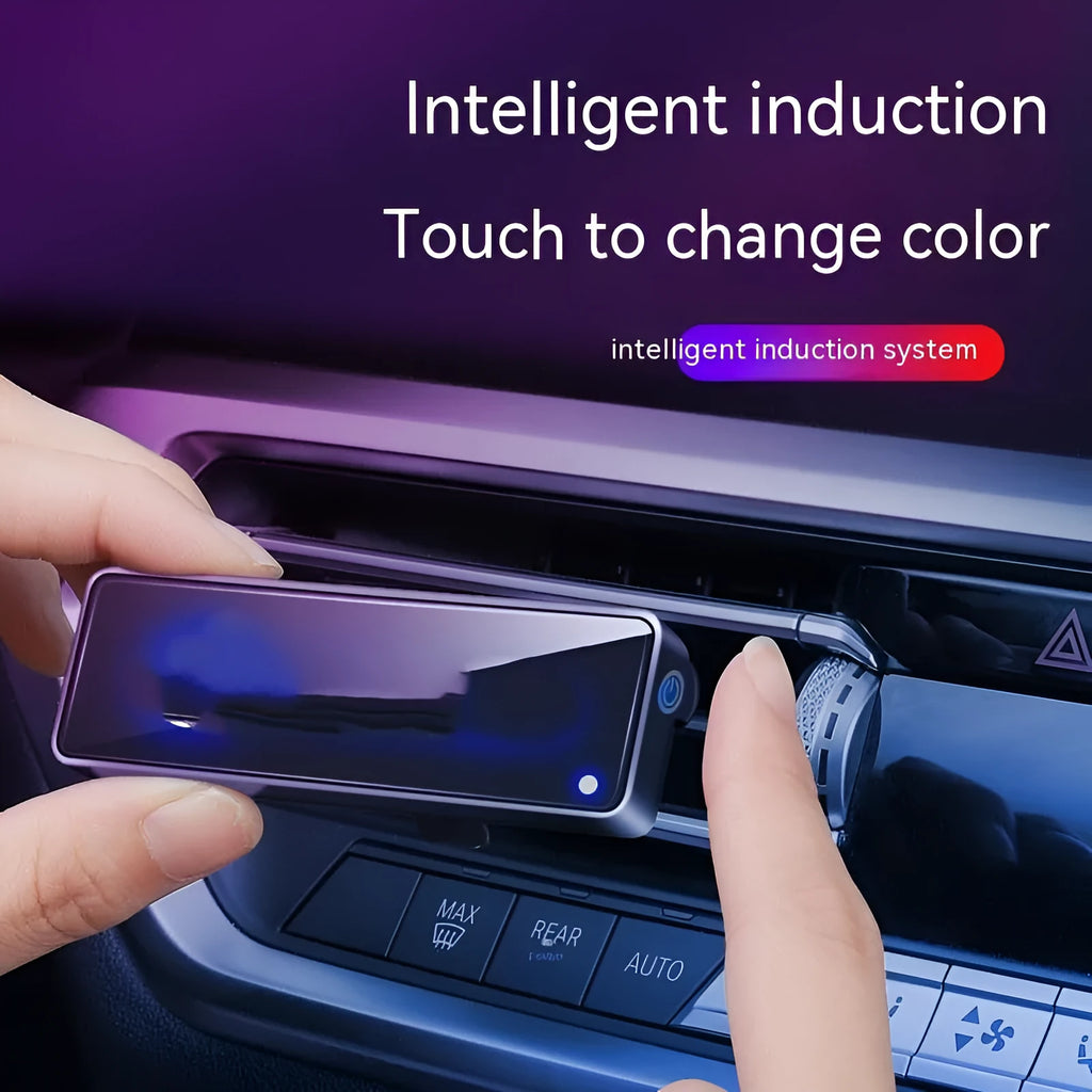 Black car air vent perfume diffuser with LED lighting mounted on vehicle dashboard