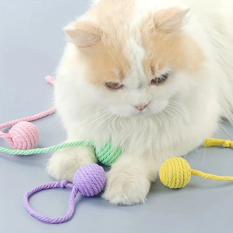 Fabric cat toy ball with rope attached in green, pink, purple, or yellow colours