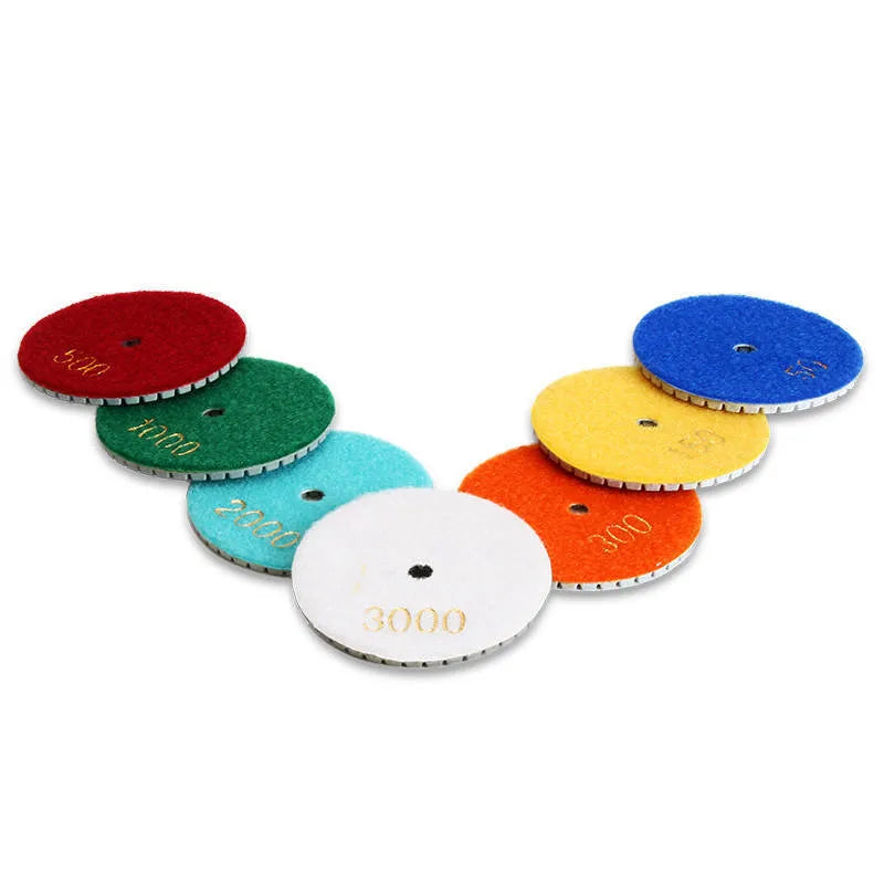 Set of 10 emery stone polishing pads showing 80mm diameter discs with central mounting holes