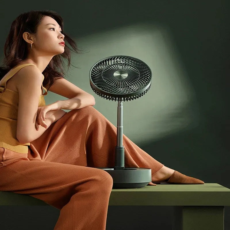 Green telescopic floor fan shown in both desktop and extended vertical positions with remote control