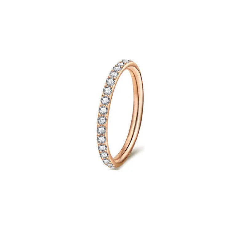 A stainless steel seamless nose ring with a diamond setting, shown in gold, rose gold, black, and steel finishes.