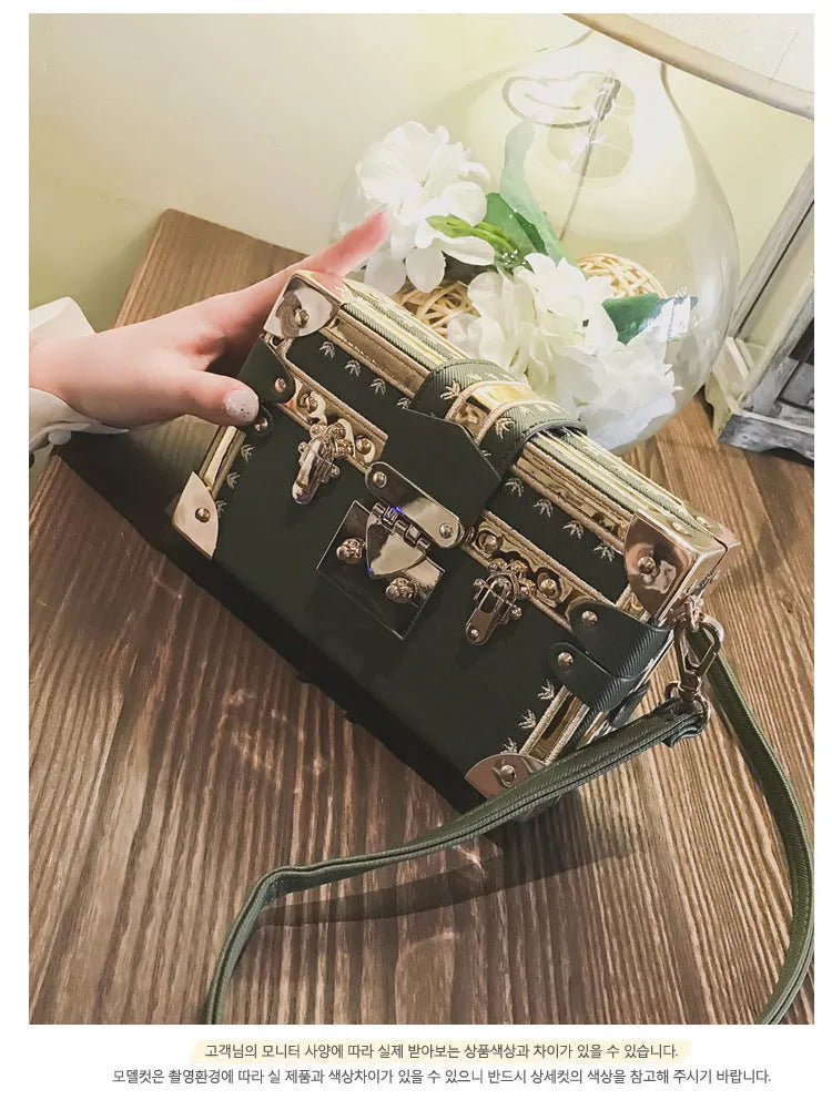 Black structured women's shoulder bag with flap and single strap.