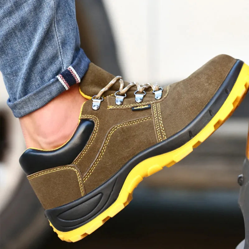 Bronze coloured low-cut cow suede leather safety shoes with a steel toe cap on a work surface.