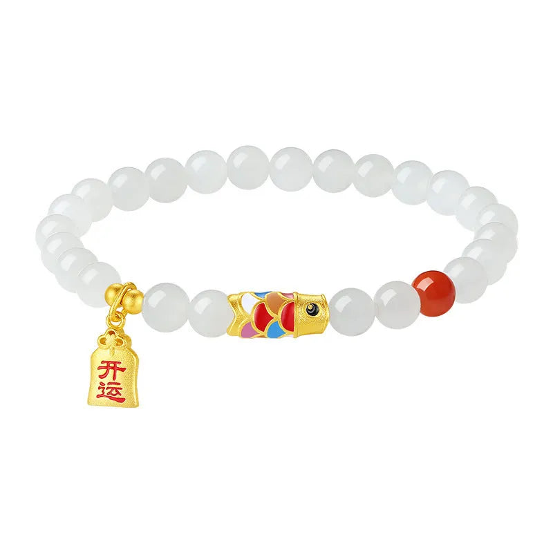 Close-up of a women's sterling silver bracelet with a koi fish cold enamel design and a natural Hetian jade component.