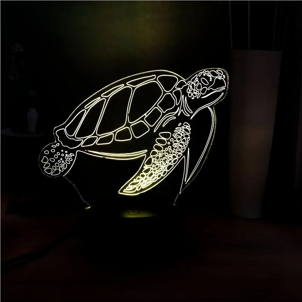3D transparent acrylic turtle-shaped LED night light glowing with coloured light.