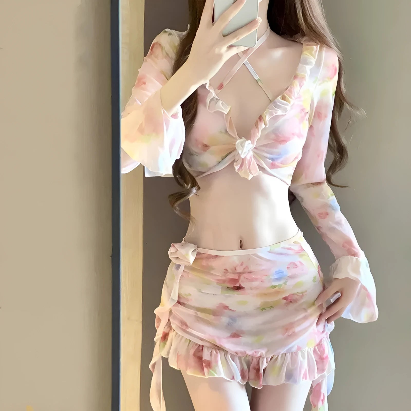 Women's cherry blossom pink floral bikini swimsuit laid flat, showing the pattern and style.