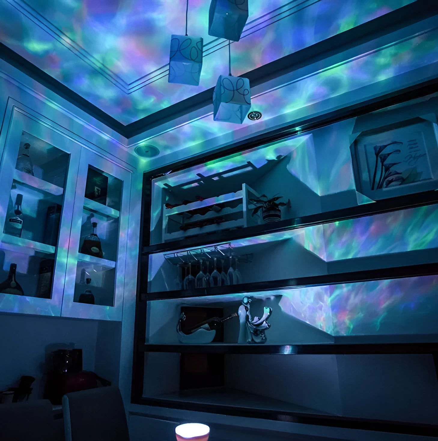 Ocean wave projector showing multicolour LED light display on a dark ceiling