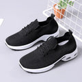 Women's black mesh lace-up sneakers with a round toe and soft sole on a white background.