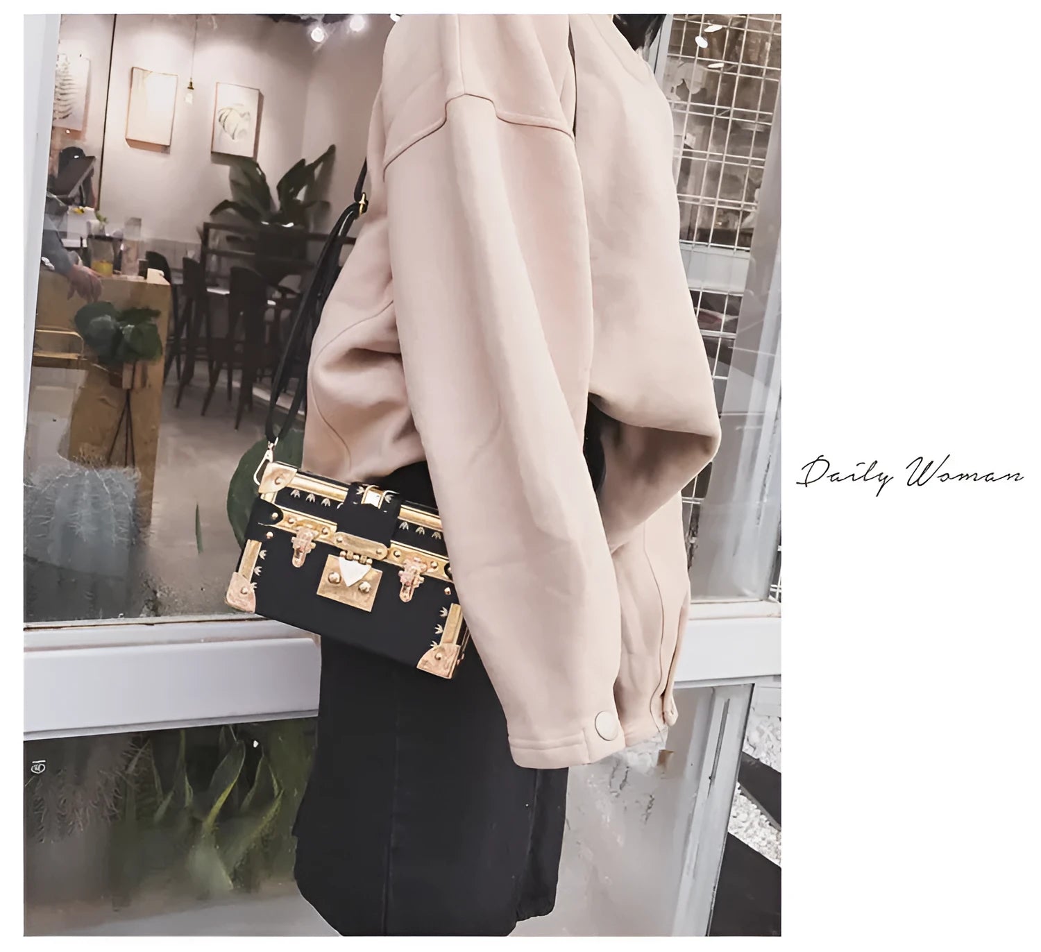 Black structured women's shoulder bag with flap and single strap.