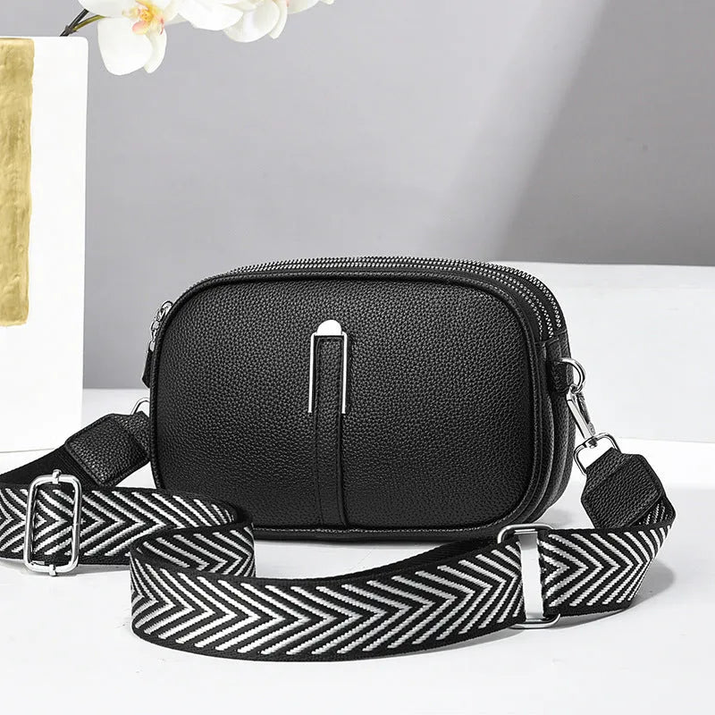 Women's soft PU crossbody bag in oval shape with multiple internal compartments and slit pocket