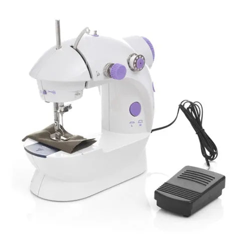 Miniature white and grey electric household sewing machine with thread spool and power cord.