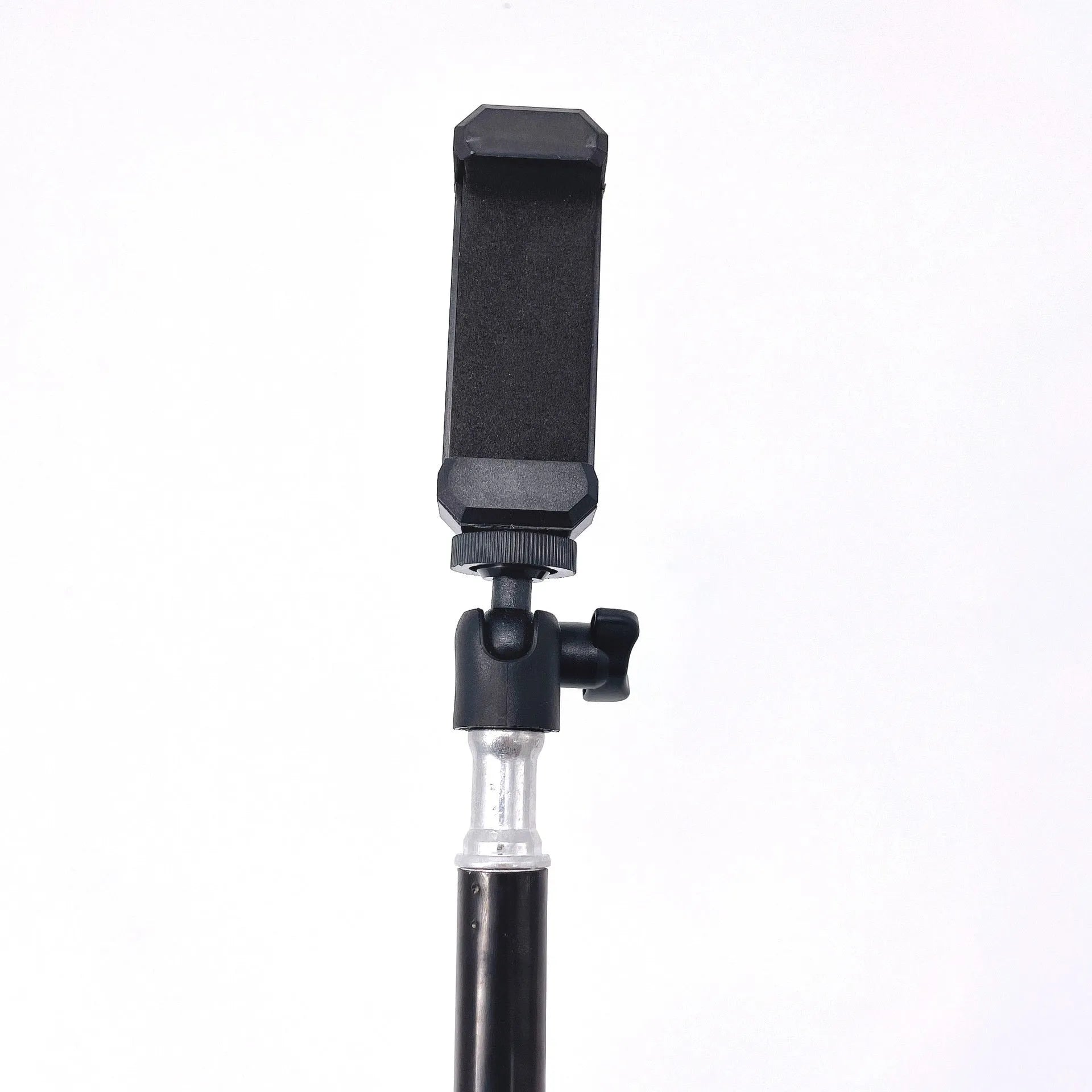 Black mobile phone tripod extended to 1.1m on a desk showing metal legs and phone mount