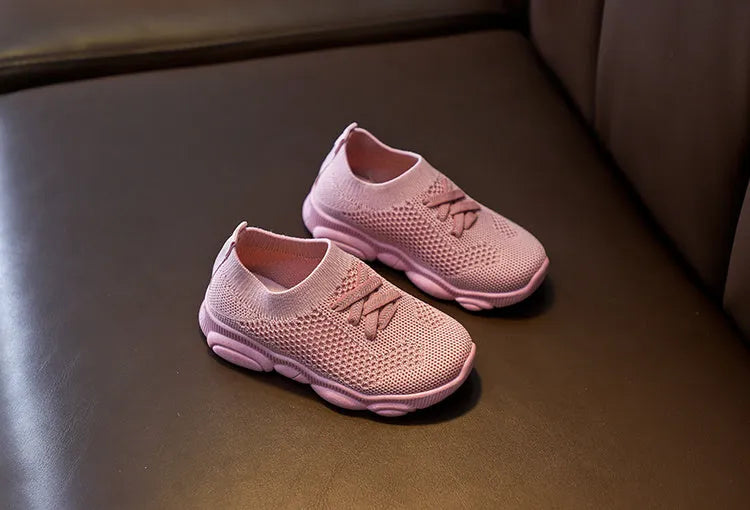 Children's lazy slip-on shoes in white, black, pink, or grey with fabric upper and rubber sole.