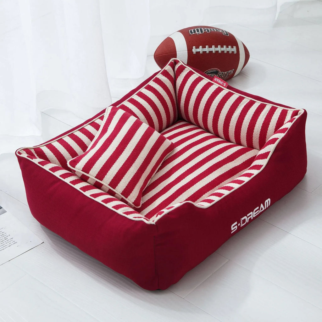 Navy striped washable dog kennel mat with removable cover and a red mini pillow.