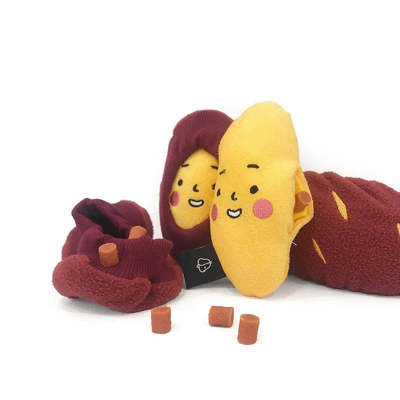Red sweet potato pet toy with a peel-off layer and hidden treat pocket for dogs and cats.