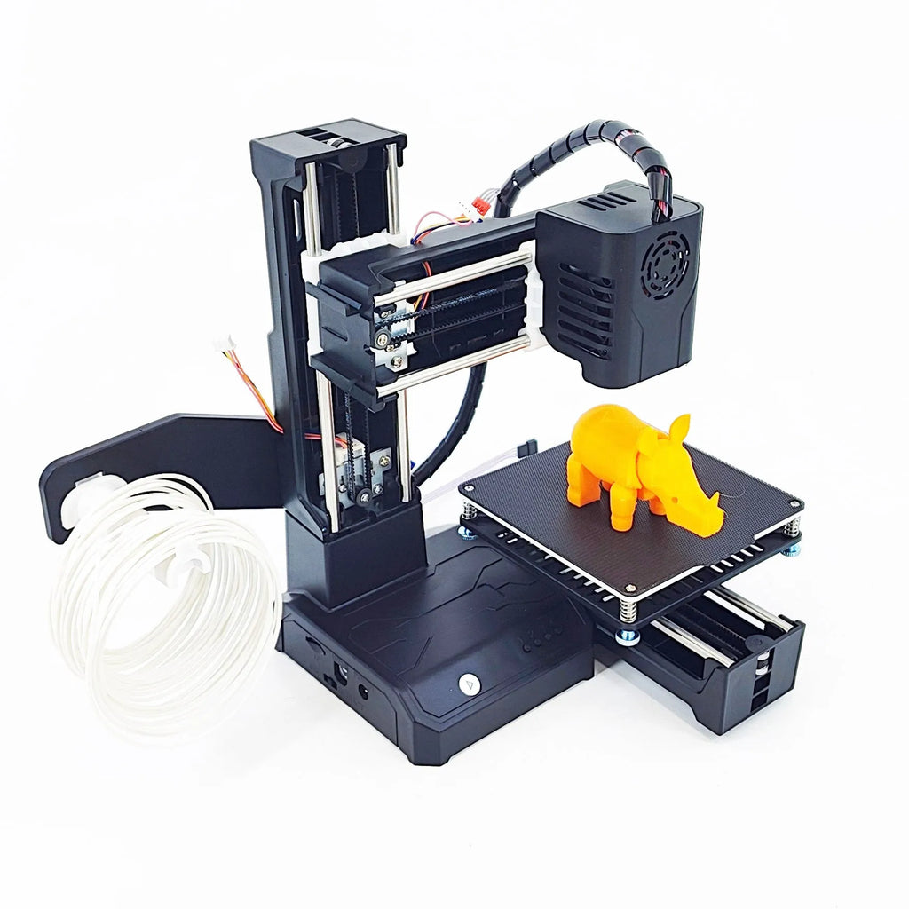 K9 New Mini 3D Printer on a desktop with a small printed toy model next to it.