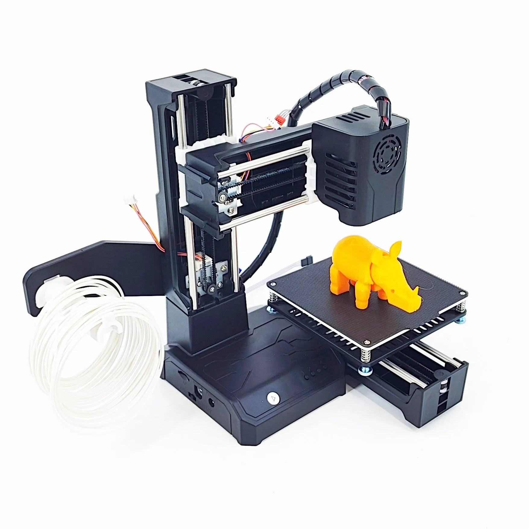 K9 New Mini 3D Printer on a desktop with a small printed toy model next to it.