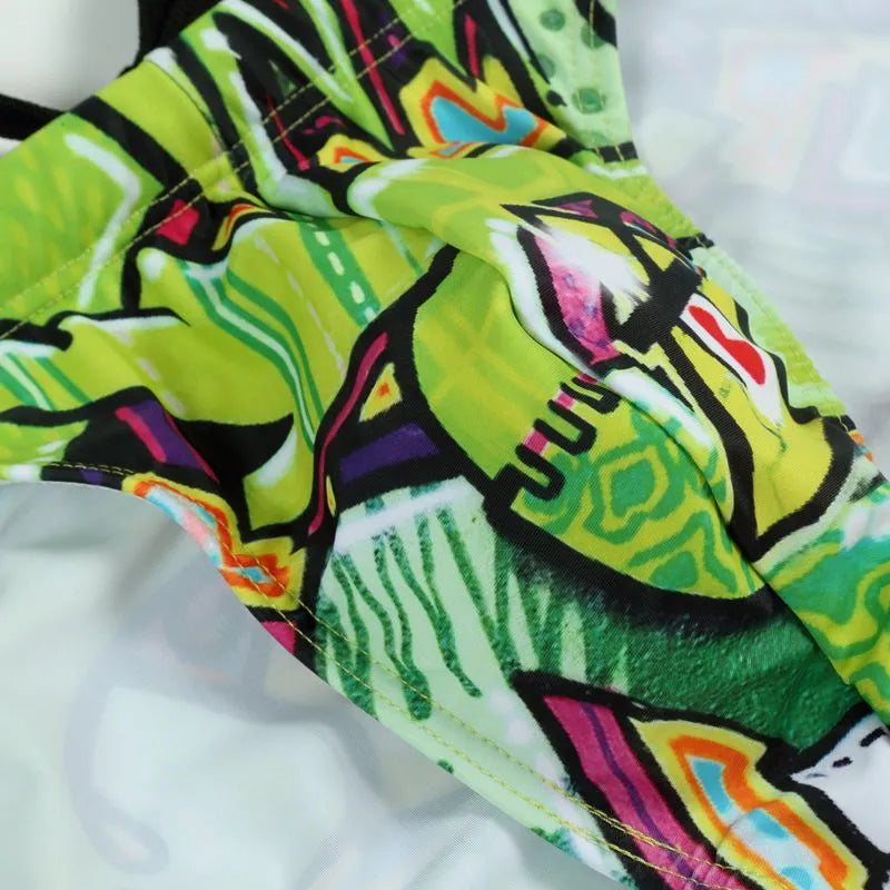 Printed men's swimming trunks in polyester fabric showing colour options Cyber, Ice Cream, Streamer, and Skull.