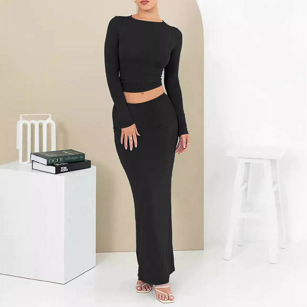Women's black sweet style two-piece suit with three-quarter sleeve top and long skirt.